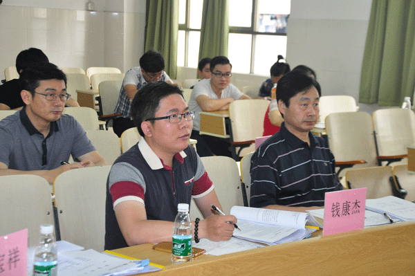 张国安主任（左）、万世明院长（右）、钱康杰总监（中）、正在认真听取学生的毕业设计汇报